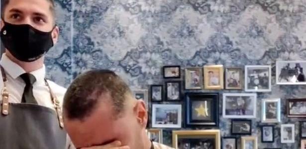 A barber shaves his hair in support of a friend with cancer