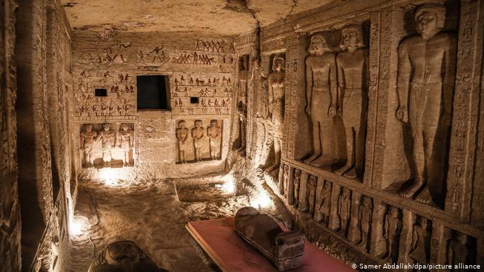 View of a tomb in Sakara, Egypt: wall decorations, paintings, and sarcophagi.