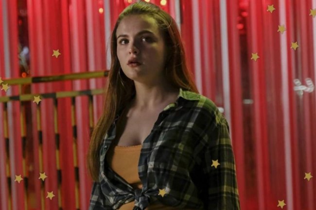 Cruel Summer Janet Focusing on the face of Janet's character, from the Cruel Summer series, she looks to the side with a serious expression in an orange plaid shirt.