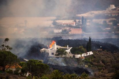 Lava swallows a house in El Paraíso on Monday.