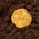An archaeologist discovers a rare medieval gold coin;  See item value |  Globalism