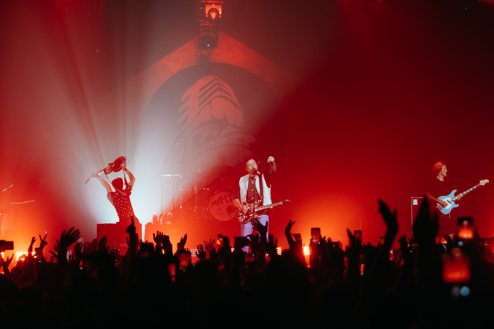 McFly on display in Sao Paulo.  The picture shows the audience, red lights and band members in the background