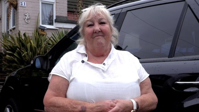 Jenny Warwick smiling near the car